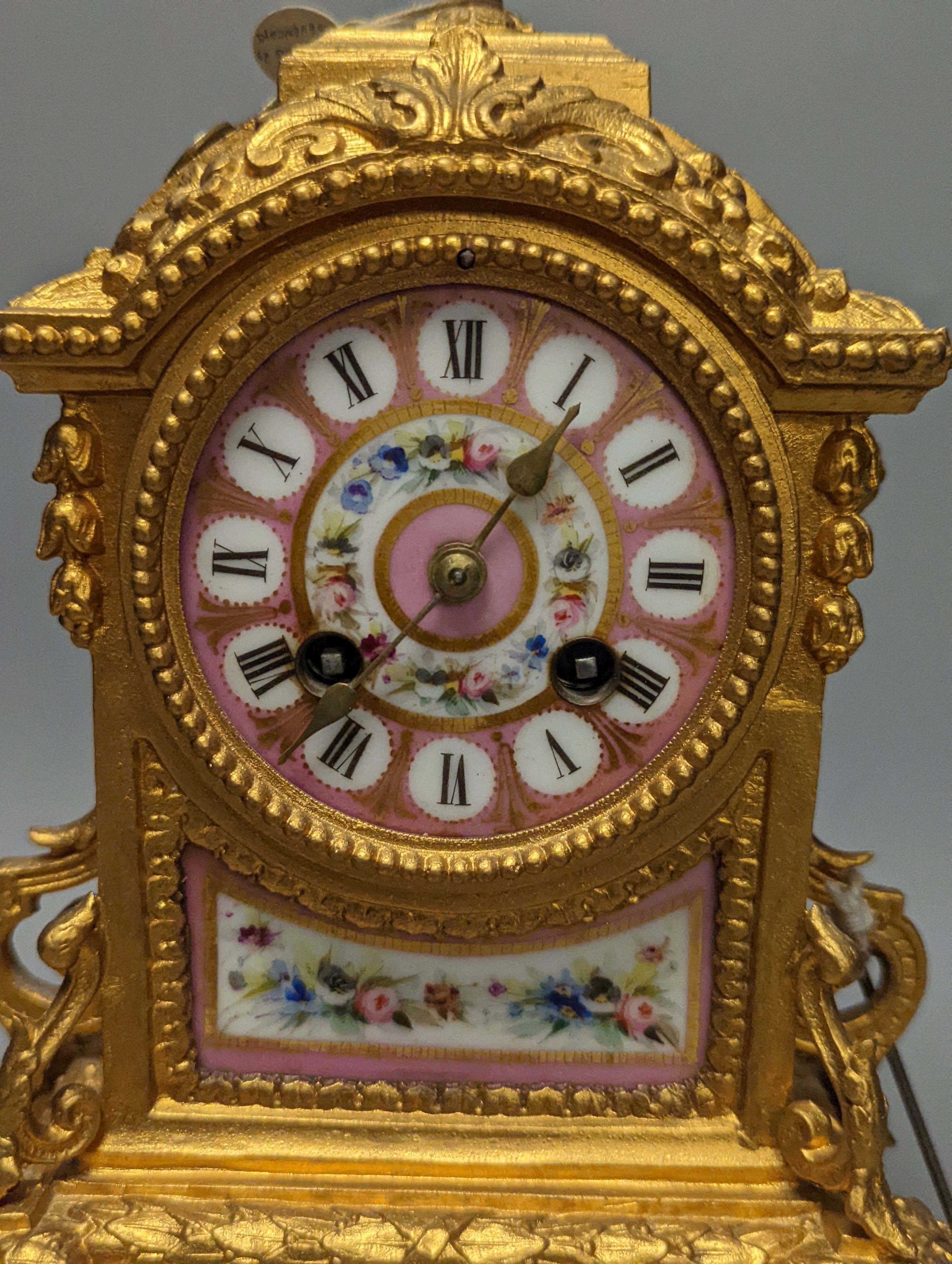 A 19th century gilt metal mantel clock on plinth with key and pendulum 30cm